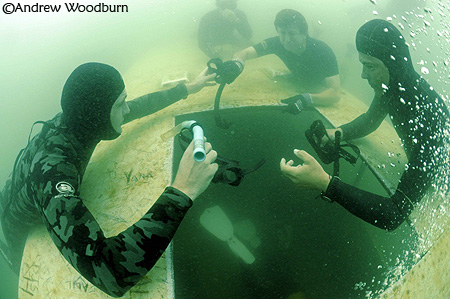 Freedivers doing mask swap training at 14m AW